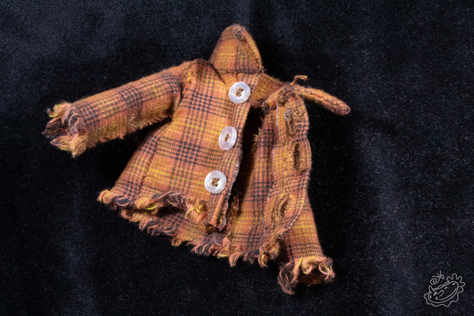 A brown flannel with distressed sleeves and three white buttons