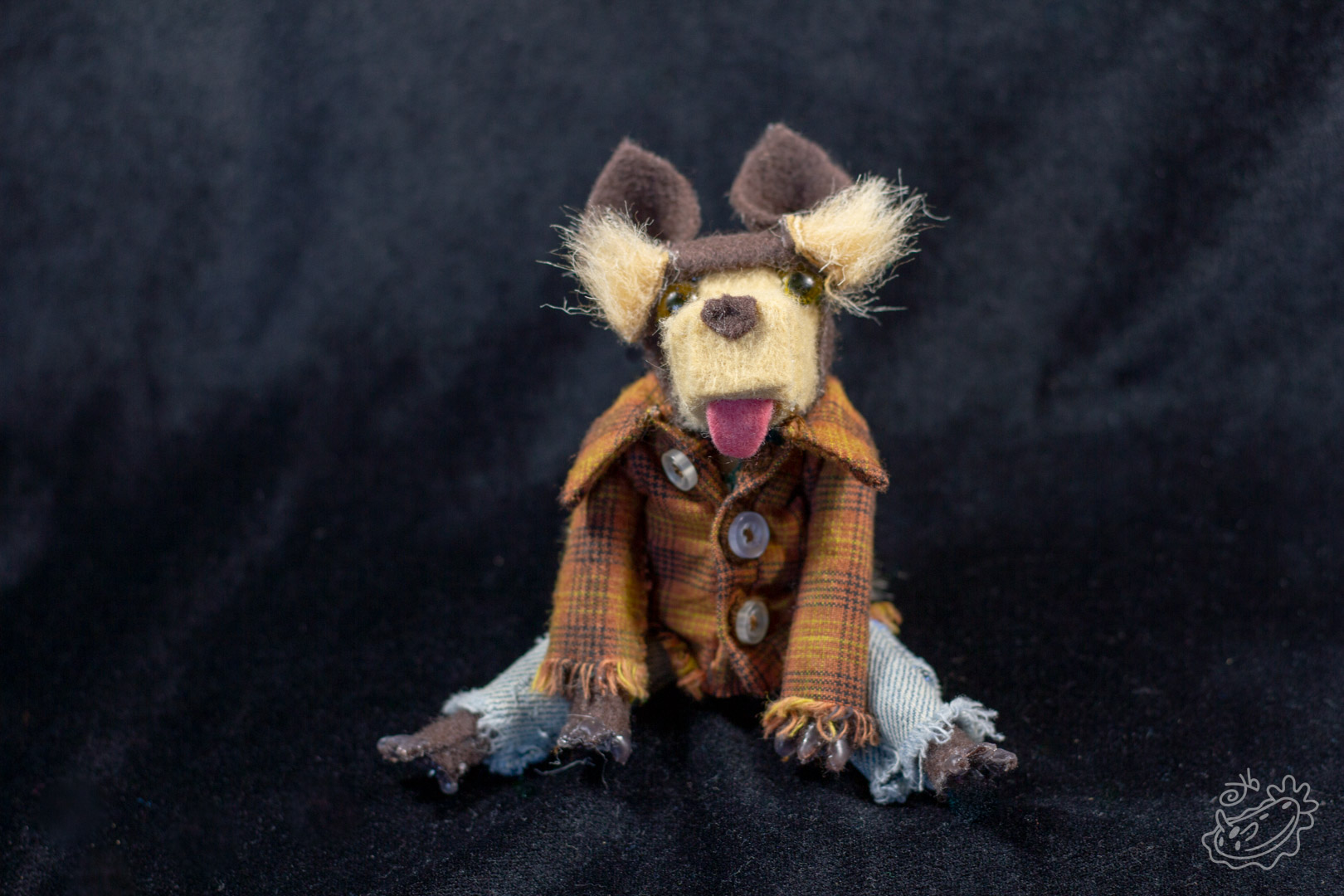 A felt doll of the Michigan Dogman. It is dressed in jeans, a band tank top with the art of the dogman on it, and a brown flannel. Front View.